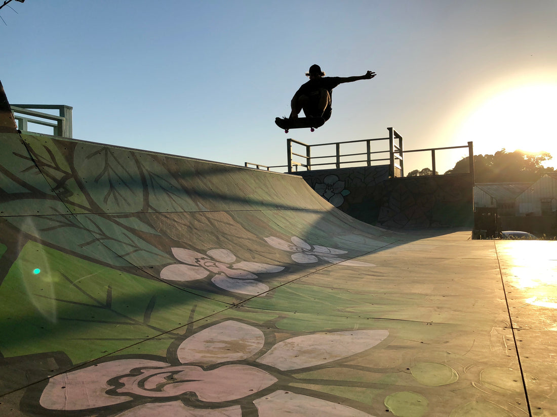 Skateboarder frontside air halfpipe sunset